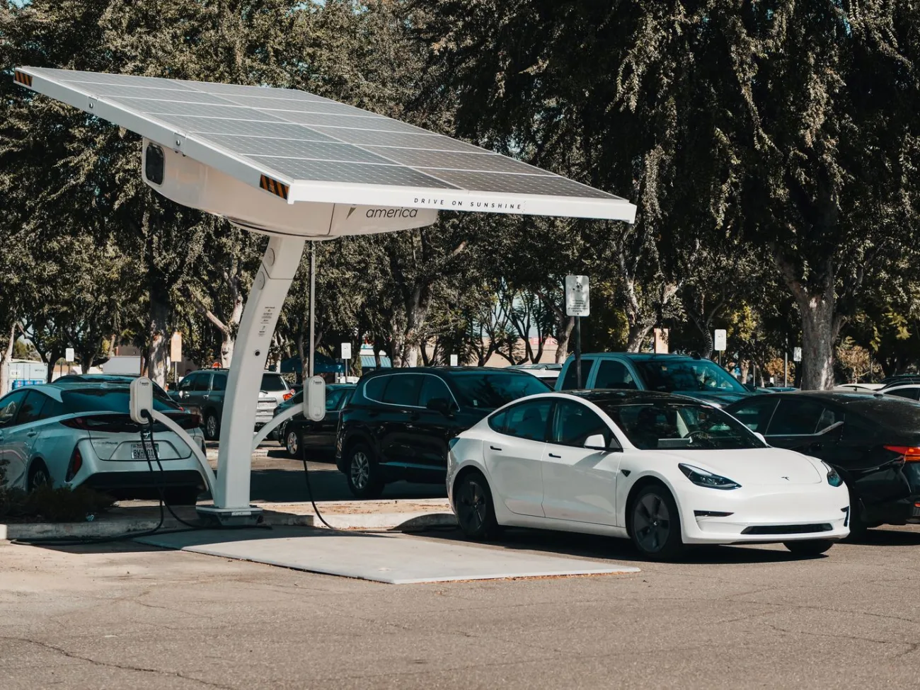 Solar-powered carport charging an electric vehicle