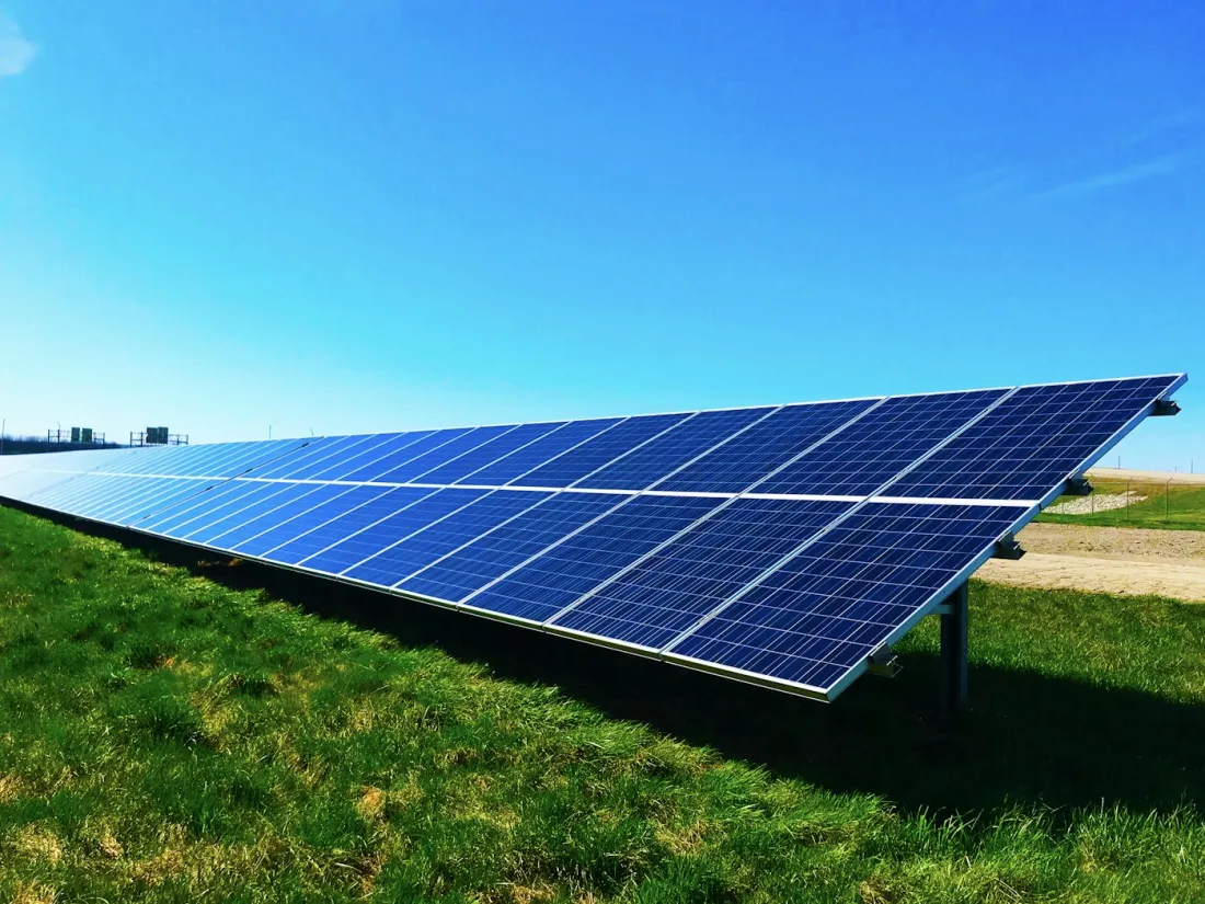 Solar panels under a bright sky
